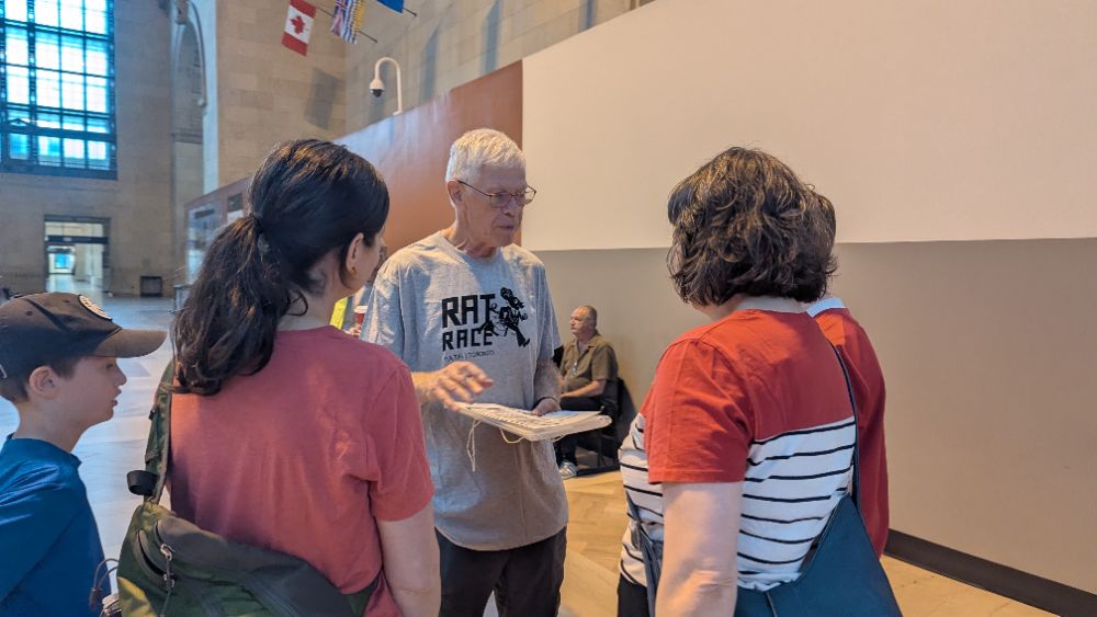 A player in a Rat Race t-shirt chatting with a family team