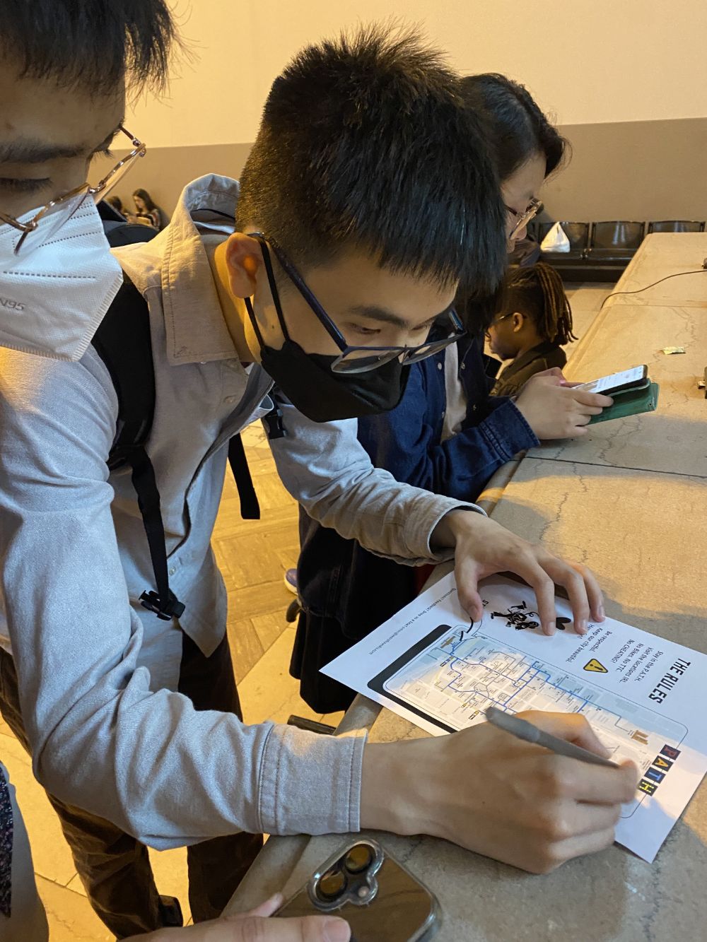 A team marking up their rules and map sheet