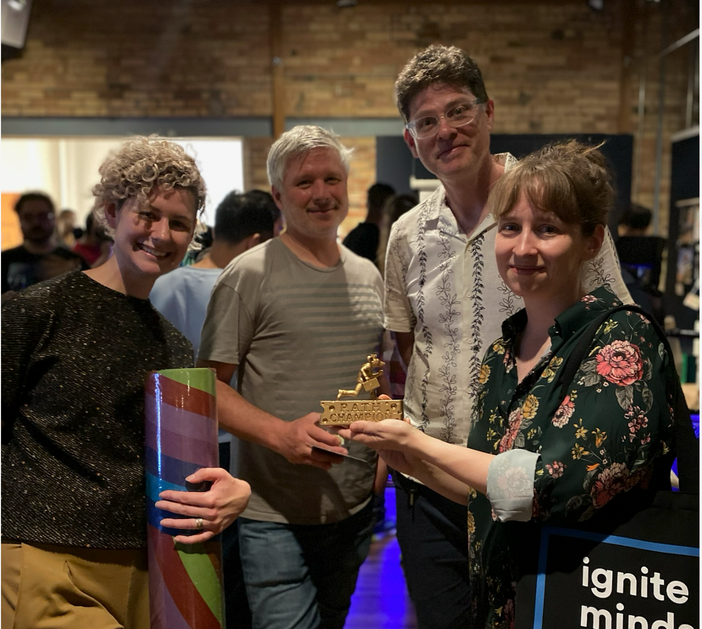 A winning team with the gold P.A.T.H. Champion trophy